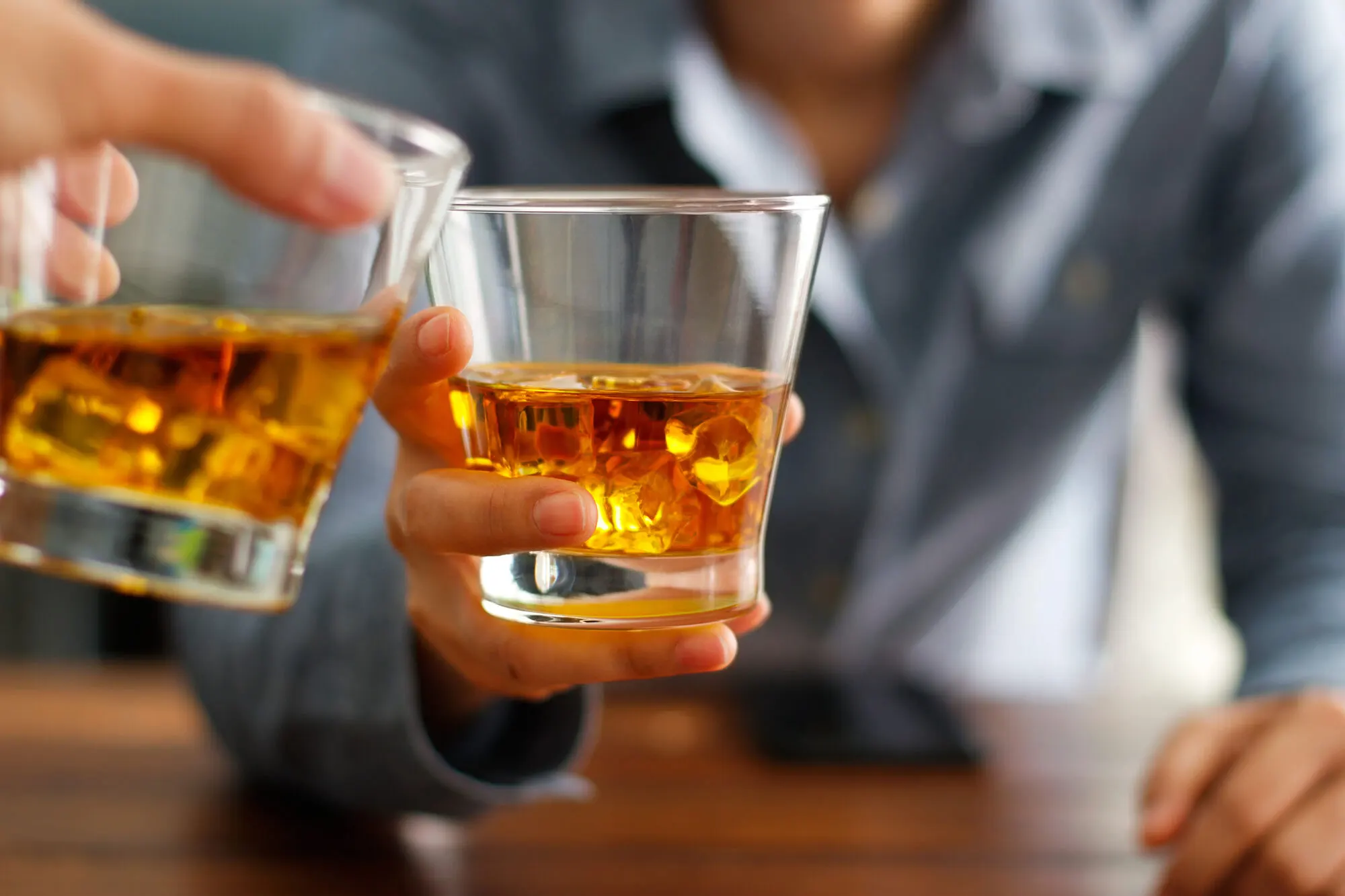 Friends toasting with whiskey